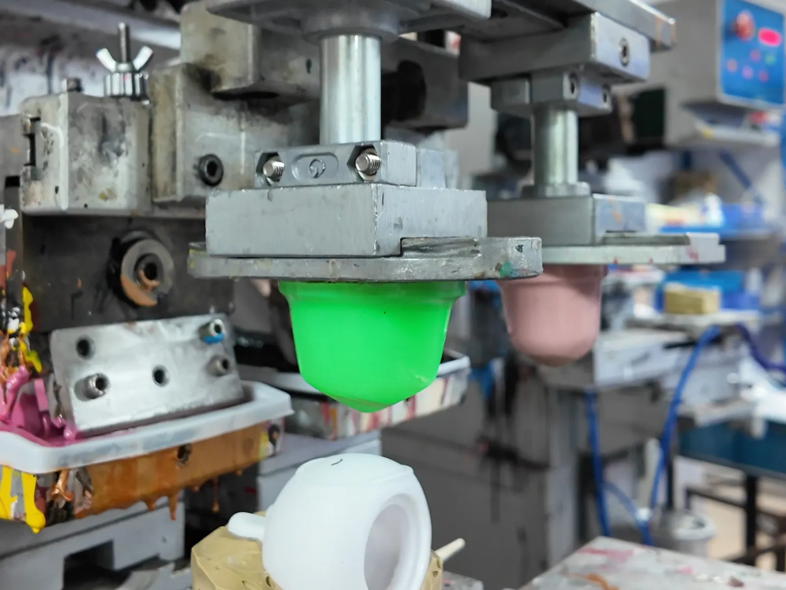 The pad printing machine in operation for toy pad printing