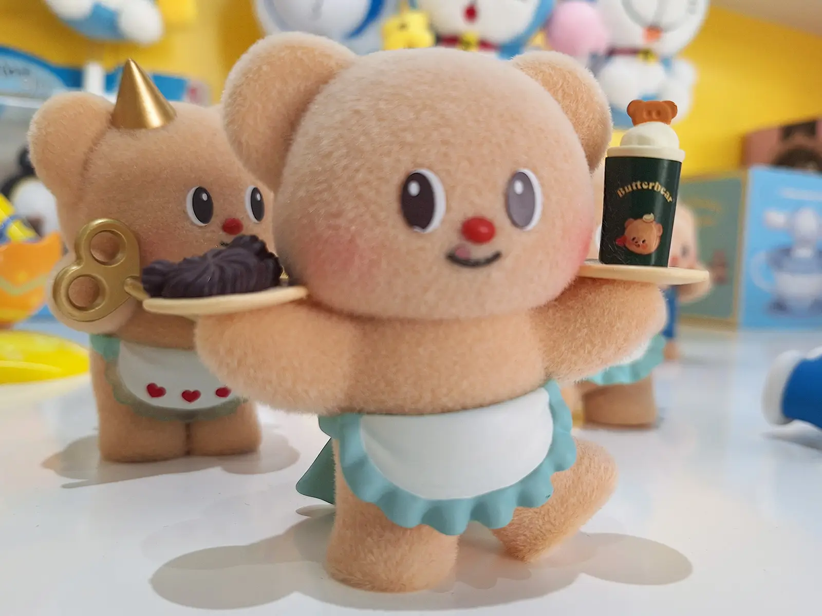 Butter Bear holding a plate and wearing an apron