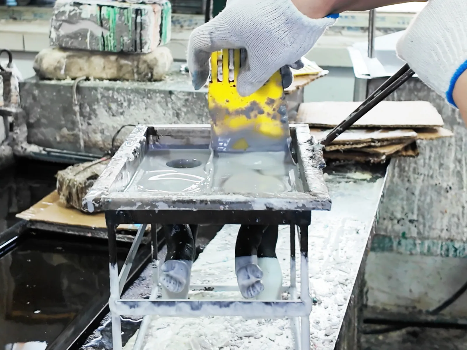 Use a scraper to push the excess PVC slurry into the vinyl mold.