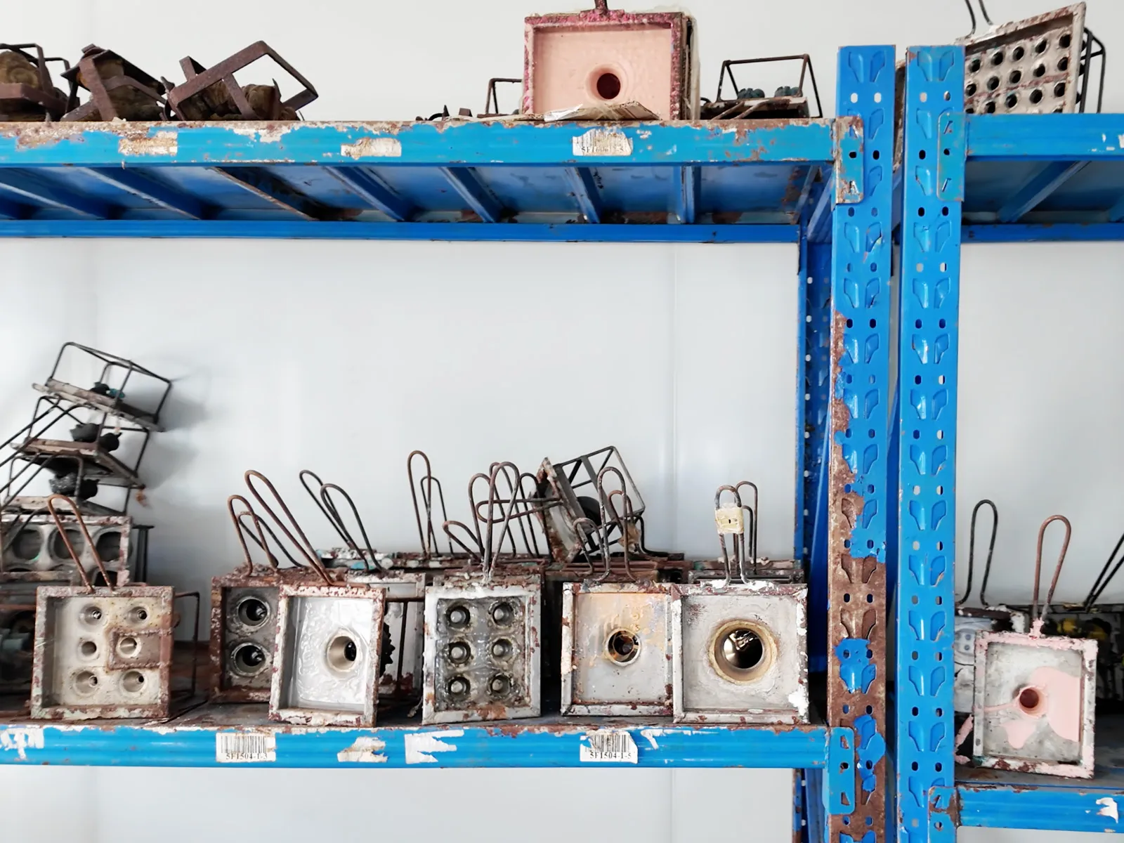 Vinyl toy molds neatly arranged on warehouse shelves.